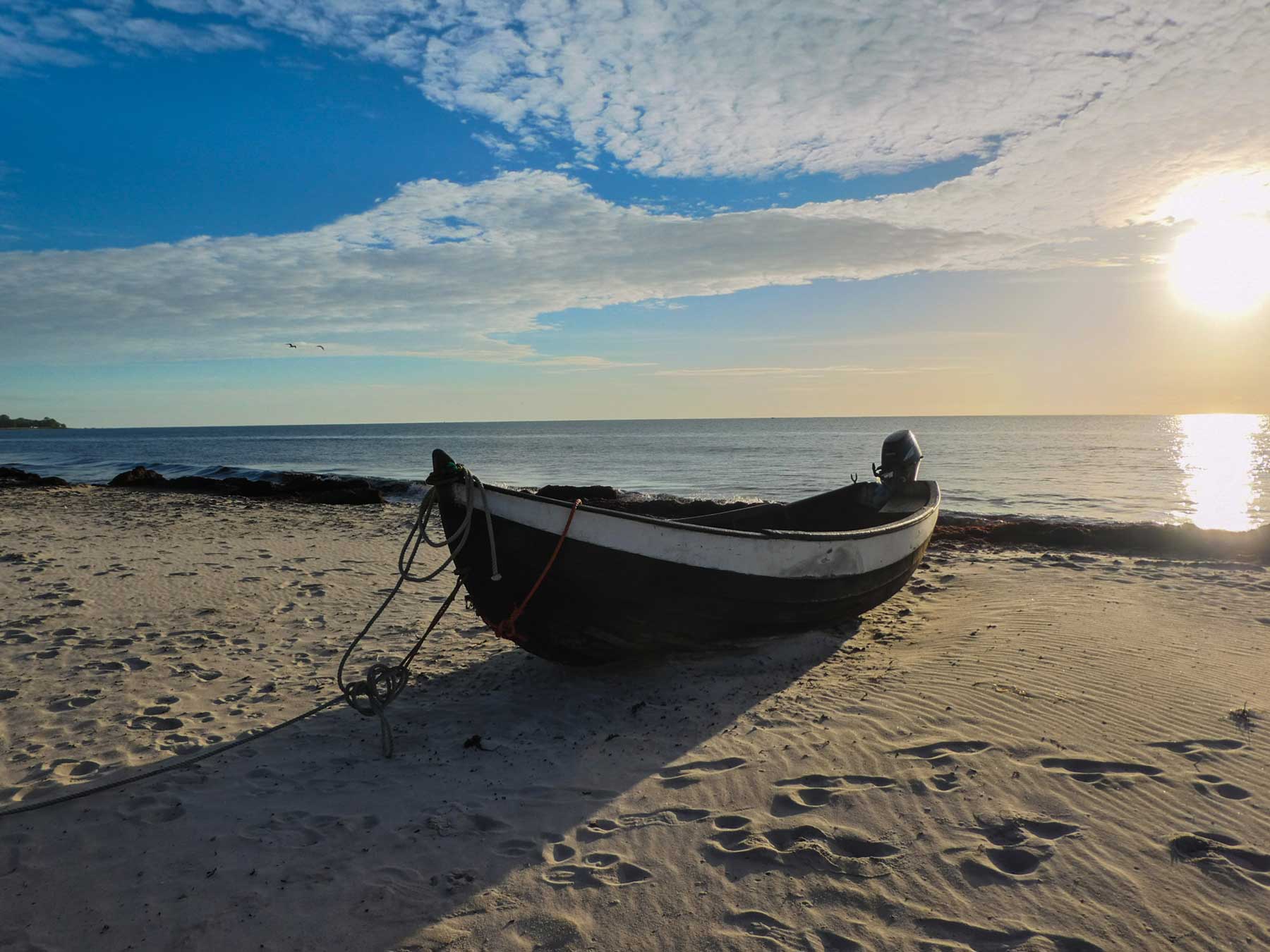 row boat sand beach sunset