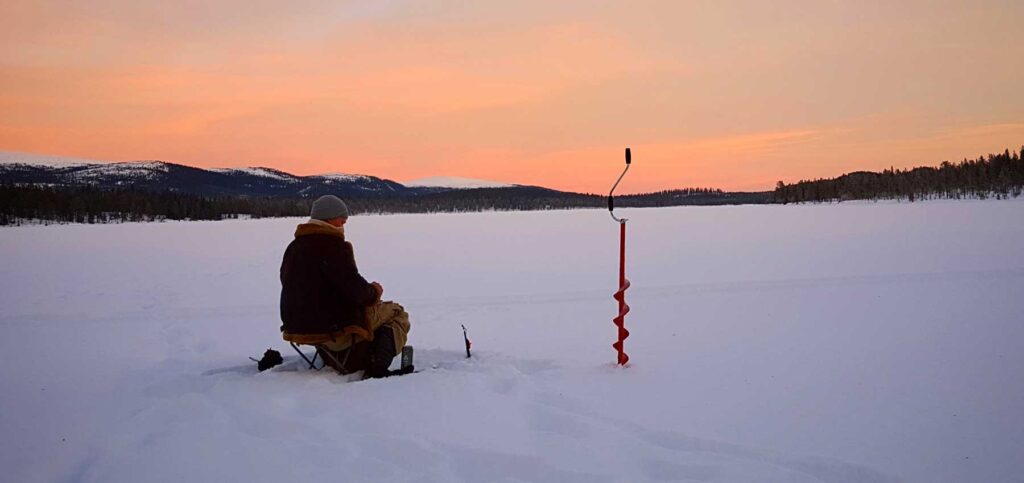 ice fishing snow frozen lake sunset